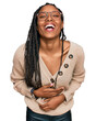 © Krakenimages.com - African american woman wearing casual clothes smiling and laughing hard out loud because funny crazy joke with hands on body.