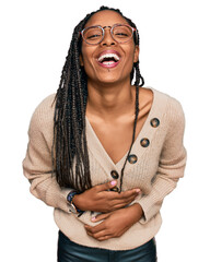 Wall Mural - African american woman wearing casual clothes smiling and laughing hard out loud because funny crazy joke with hands on body.