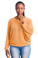 Poster - Young african american woman wearing casual clothes asking to be quiet with finger on lips. silence and secret concept.