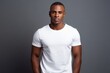 © Anatolii - Black History Month, African man with healthy clean skin wearing white t-shirt against gray studio wall with copy space