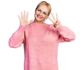 Wall Mural - Young blonde woman wearing casual clothes and glasses showing and pointing up with fingers number eight while smiling confident and happy.