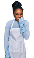 Wall Mural - Young african american woman wearing apron looking stressed and nervous with hands on mouth biting nails. anxiety problem.