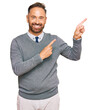 © Krakenimages.com - Handsome middle age man wearing business clothes smiling and looking at the camera pointing with two hands and fingers to the side.