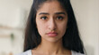 © Yuliia - Close up head shot frustrated sad lonely Indian ethnic woman businesswoman looking at camera pensive anxious sight depressed thoughts portrait girl worried with health problem guilt loneliness despair