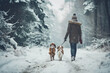 A couple in love with a pet spaniel dog on a snowy walk in the countryside in winter