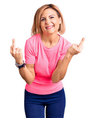 Poster - Young blonde woman wearing sportswear showing middle finger doing fuck you bad expression, provocation and rude attitude. screaming excited