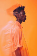 © ADDICTIVE STOCK - Poised black man with dynamic orange backdrop. Generative AI image