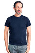 © Krakenimages.com - Middle age handsome man wearing casual t-shirt smiling looking to the side and staring away thinking.