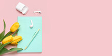 Modern Earphones, Notebook, Pen And Beautiful Tulip Flowers On Pink Background With Space For Text