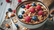 Delicious bowl of yogurt topped with fresh berries and crunchy granola. Perfect for healthy breakfast or snack.