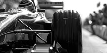 A Black And White Photo Of A Racing Car. Suitable For Automotive Enthusiasts And Sports-related Projects