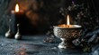 A lit candle in an ornate silver holder against a dark backdrop