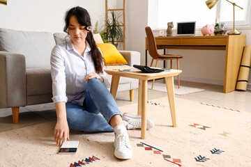 Sticker - Young woman planning budget at home