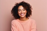 Fototapeta  - Portrait of a beautiful young african american woman smiling over pink background