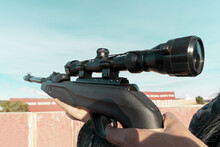 A Rifle With An Optical Sight Close-up In The Hands Of A Man, Selective Focus. Military Action, Sniper Shooting Process