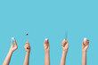 © Pixel-Shot - Female hands with teeth models and dental tools on blue background