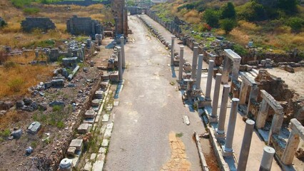 Wall Mural - In this captivating aerial stock video, the remarkable ruins of the ancient city of Perge in contemporary city of Antalya, Turkey are shown. 