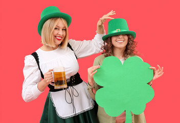 Poster - Portrait of women with beer and paper clover celebrating St. Patrick's Day on red background