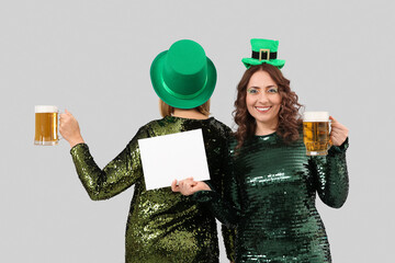 Poster - Women with blank card and beer celebrating St. Patrick's Day on light background