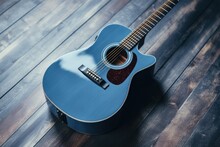 Blue Acoustic Guitar On Gray Wooden Background.