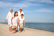 © New Africa - Cute little children with grandparents spending time together on sea beach
