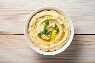 Wall Mural - Top view of homemade hummus on white wooden background