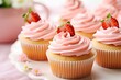 Cupcakes with strawberry cream cheese frosting swirled