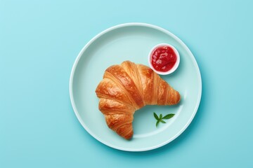 Poster - Freshly baked croissant with jam on a blue plate isolated on white background viewed from the top