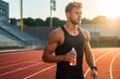 Pumped up athlete with bottle of water at stadium preparing for run at dawn