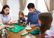 © Dasha Petrenko - Happy young family plaing board game
