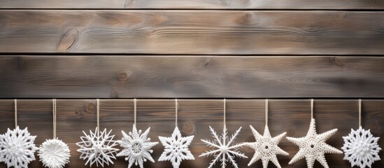 Canvas Print - Handcrafted white yarn snowflakes on wooden table, room for text, horizontal composition.