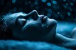 A woman with a glowing blue face and glowing magical shiny skin laying on top of a bed covered in snow.