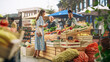 © Gorodenkoff - Middle Aged Diverse Couple Running a Small Business on a Farmers Market, Selling Organic Fruits and Vegetables. Young Female Shopping For Food, Choosing a Fresh Courgette or Zucchini