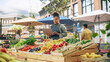 © Gorodenkoff - Successful Female Farmer Working on a Laptop Computer, Catching Up with Supplier Online to Plan Future Orders for Her Organic Street Vendor Stall with Sustainable Fruits and Vegetables