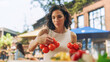 © Gorodenkoff - Young Beautiful Customer Shopping for Fresh Seasonal Fruits and Vegetables for a Mediterranean Dinner. Black Female Buying Sustainable Bio Tomatoes From an Ecological Local Street Vendor