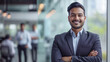 © Farnaces - Portrait of a handsome smiling asian indian businessman boss standing in his modern business company office.