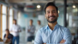 © Farnaces - Portrait of a handsome smiling asian indian businessman boss standing in his modern business company office.
