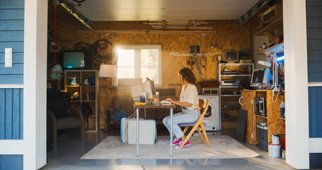Fototapete - Hispanic Female Software Developer Programming On Old Desktop Computer In Retro Garage With Random Appliances. Woman Working On Innovative Online Service Startup Company In Nineties. Nostalgia Concept