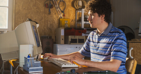 Fototapete - Caucasian Male Software Engineer Programming On Old Desktop Computer In Retro Garage. Enthusiast Browsing Early Internet Forums, Coding Applications In Nineties. Nostalgia Concept