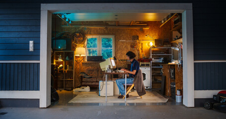 Leinwandbilder - Caucasian Male Software Engineer Programming On Old Desktop Computer In Retro Garage In The Evening. Ambitious Man Starting an Innovative Fintech Startup Company In Nineties. Nostalgia Concept.
