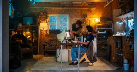 Fototapete - Two Caucasian Male Tech Startup Founders Using Old Desktop Computer In Retro Garage In The Evening. Software Developer And User Experience Designer Starting New E-commerce Business In Nineties.