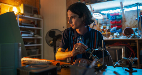 Fototapete - Portrait Of Caucasian Male Software Engineer Programming on Old Desktop Computer In Retro Garage In The Evening. Man Starting Tech Startup Company In Nineties. Coding Innovative Online Service At Home