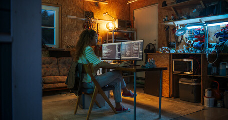 Fototapete - Hispanic Female Programmer Writing Code On Desktop Computer In Garage At Home. Woman Working On Innovative Software As A Service Startup For Business At Night. Digital Entrepreneur Starting Company.