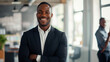 © Farnaces - Portrait of a handsome smiling black businessman boss standing in his modern business company office.