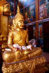 Poster - Mongkol Serei Kien Khleang Pagoda. Golden buddha statue with jasmine flowers.  Phnom Penh; Cambodia.