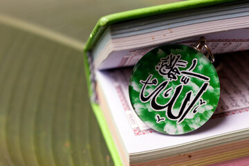 Poster - The Quran, holy book of Muslims from God with Allah monogram. Symbols of islam.