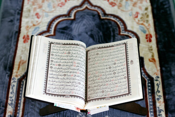 Poster - Mubarak mosque. Open Quran in arabic on wood stand. Symbol of Islam. Vietnam.