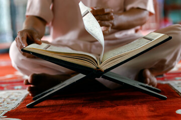 Poster - Mubarak mosque. Muslim man sitting in mosque and reading the Quran (Koran) the holu book of Islam. Vietnam.