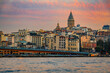 Sunrise cityscape of the Karakoy area across Bosphorus Strait by Galata Bridge with the Galata Tower at the golden hour of sunrise in Istanbul, Turkey