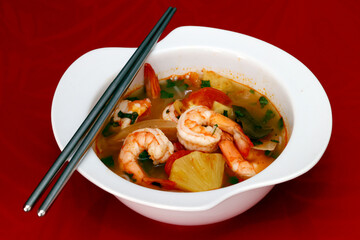 Sticker - Bowl of spicy Thai Tom Yum Soup with prawns. .